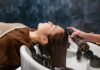 “내 머리결, 내가 지킨다”… 건강한 헤어 케어, 일상에서 시작하세요 a woman getting her hair washed in a sink