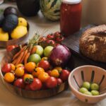달라지는 여성 건강관리 패러다임, 일상에서 실천하는 작은 변화들 Fresh produce including tomatoes, carrots, and avocados on a counter.