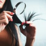 건강한 두피와 아름다운 머릿결, 생활 속 머리카락 관리법이 주목받는다 Woman examining split ends of hair with magnifying glass