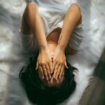 “스트레스, 이렇게 다스려요”… 일상 속 작지만 효과적인 스트레스 관리법 주목 a woman holds her hands over her face