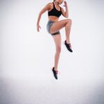 “틈새 시간을 활용하라! 마이크로 워크아웃으로 건강 챙기기” woman jumping near white wall paint